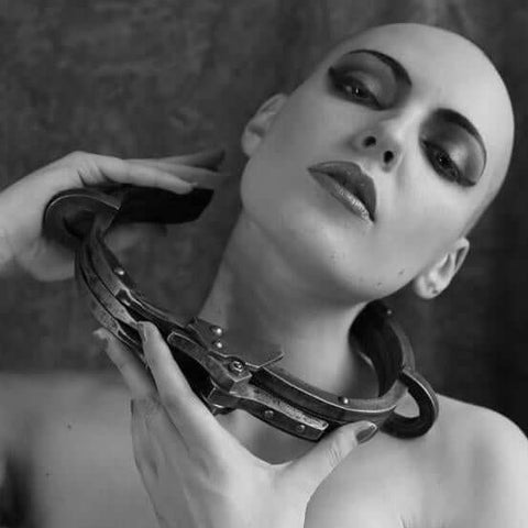 young woman holding a metal BDSM collar
