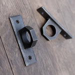 Pair of hand-forged metal hardpoints with a 2 inch ring design, mounted on a wooden surface—ideal for BDSM furniture or as industrial-style handles.