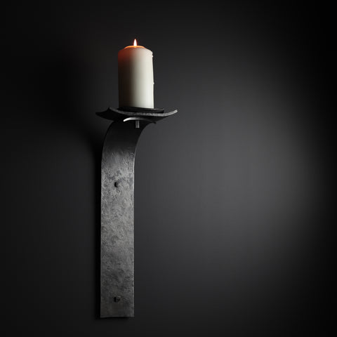 wrought iron candle sconce mounted to a wall made by gaaluub